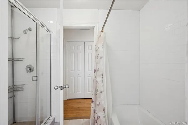 a bathroom with a shower and a glass door