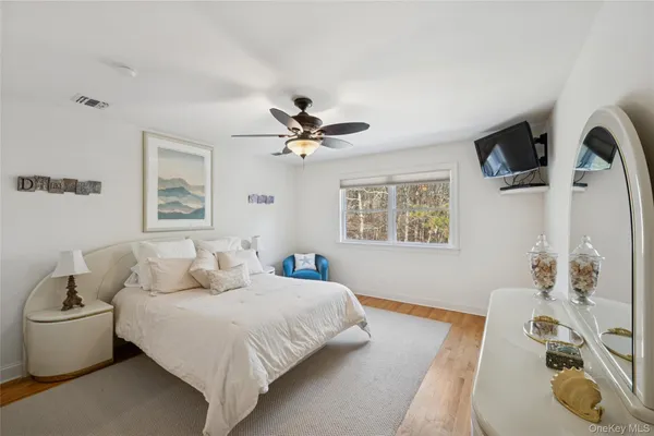 a bedroom with a large bed and a chandelier