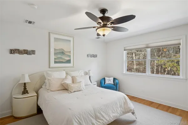 a bedroom with a large bed and a window