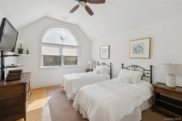 a bedroom with two beds and a flat screen tv