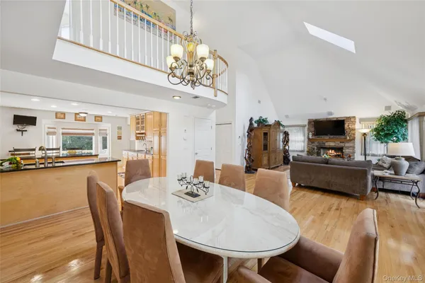a dining room with furniture a chandelier and wooden floor