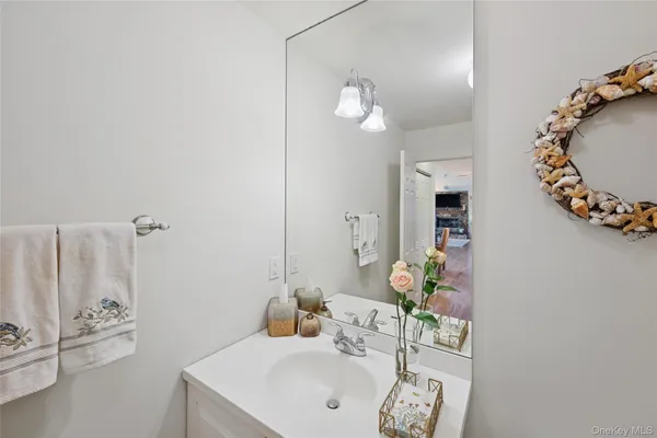 a bathroom with a sink mirror and vanity