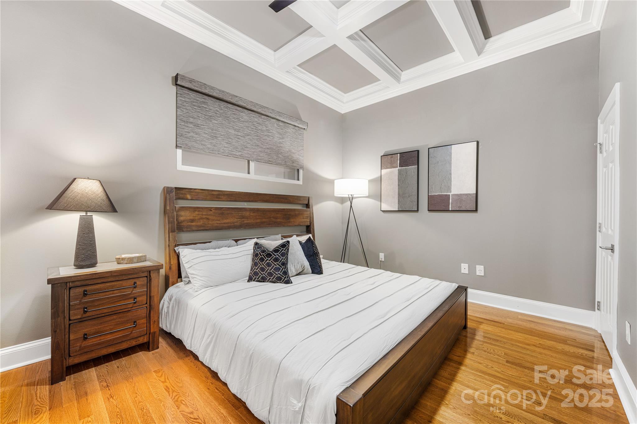 127 North Tryon Street, Unit 511 Charlotte, NC 28246 - Photo 18 of 32 a bedroom with a bed and a night stand