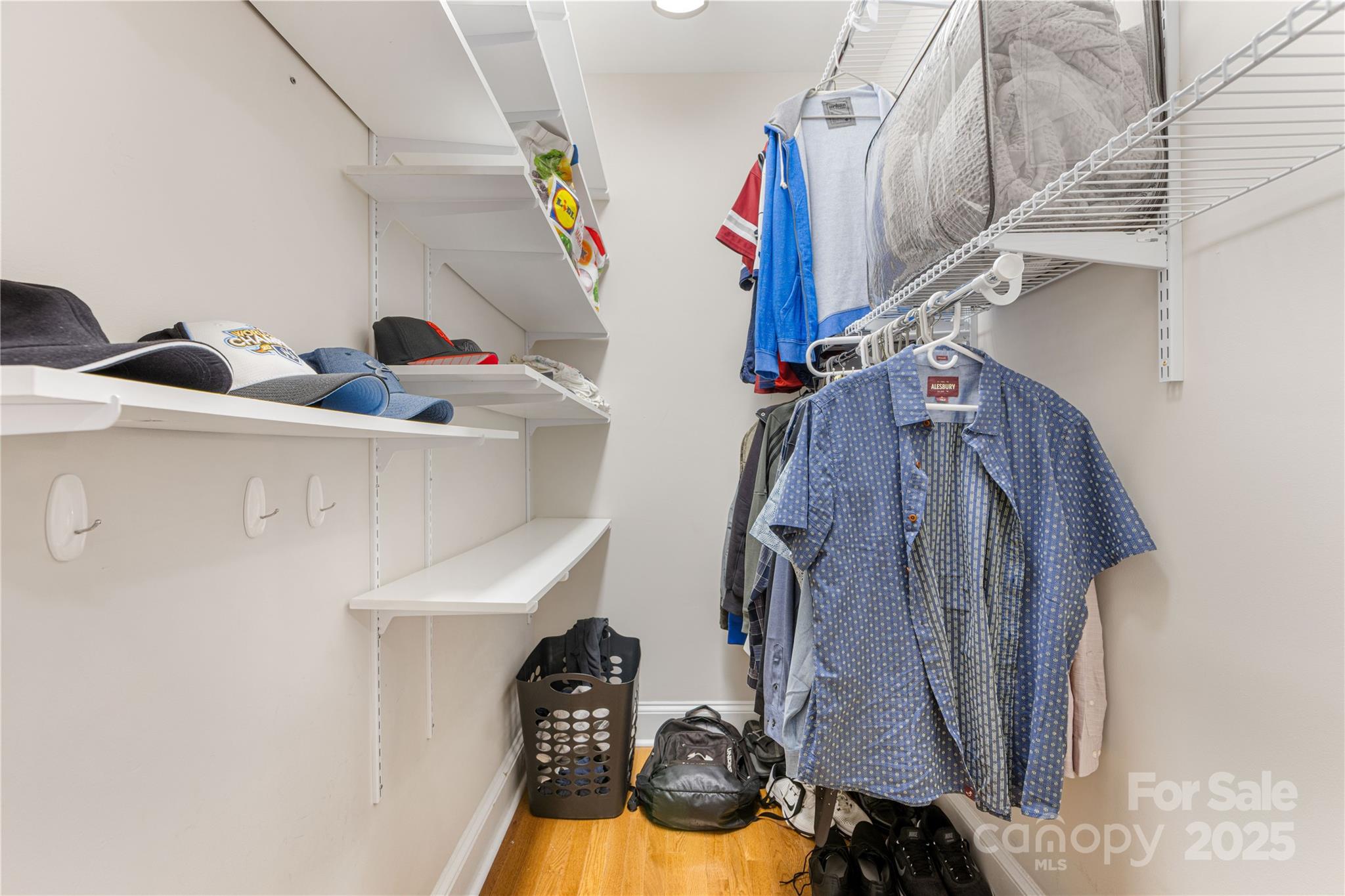 127 North Tryon Street, Unit 511 Charlotte, NC 28246 - Photo 20 of 32 a view of walk in closet with clothes and shoes