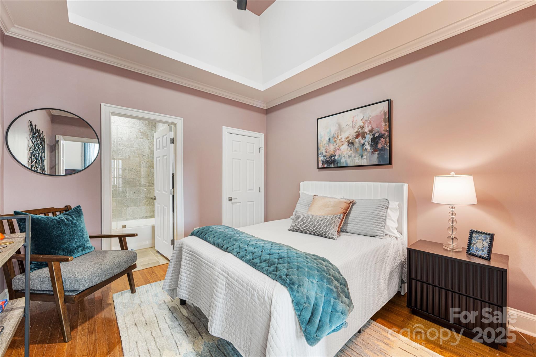 127 North Tryon Street, Unit 511 Charlotte, NC 28246 - Photo 21 of 32 a bedroom with a bed and a painting on the wall