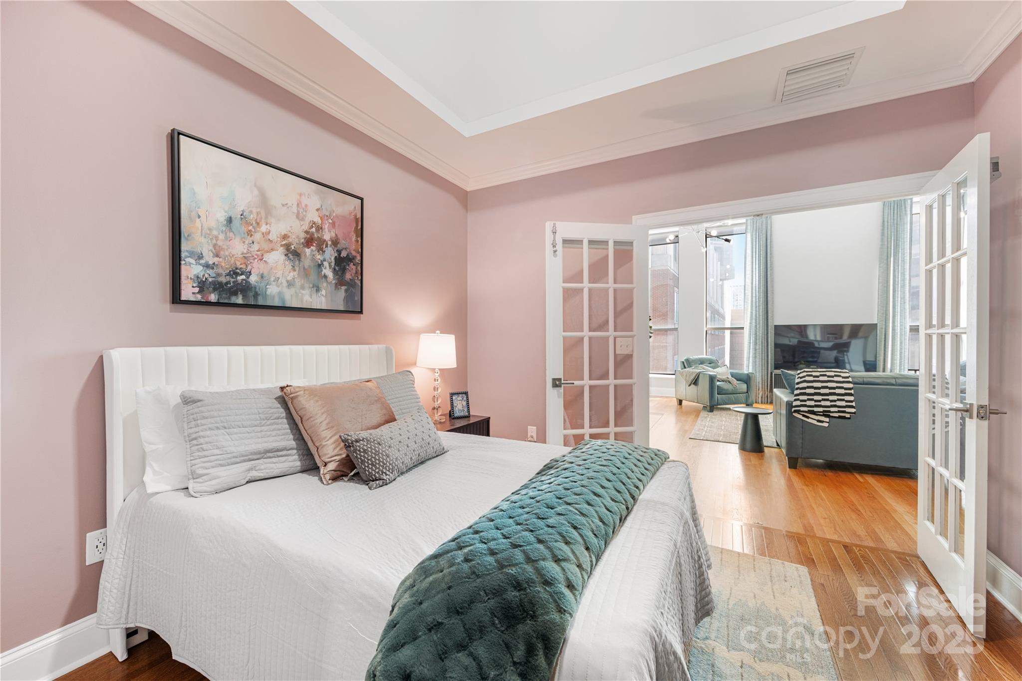 127 North Tryon Street, Unit 511 Charlotte, NC 28246 - Photo 23 of 32 a bedroom with a large bed and a couch