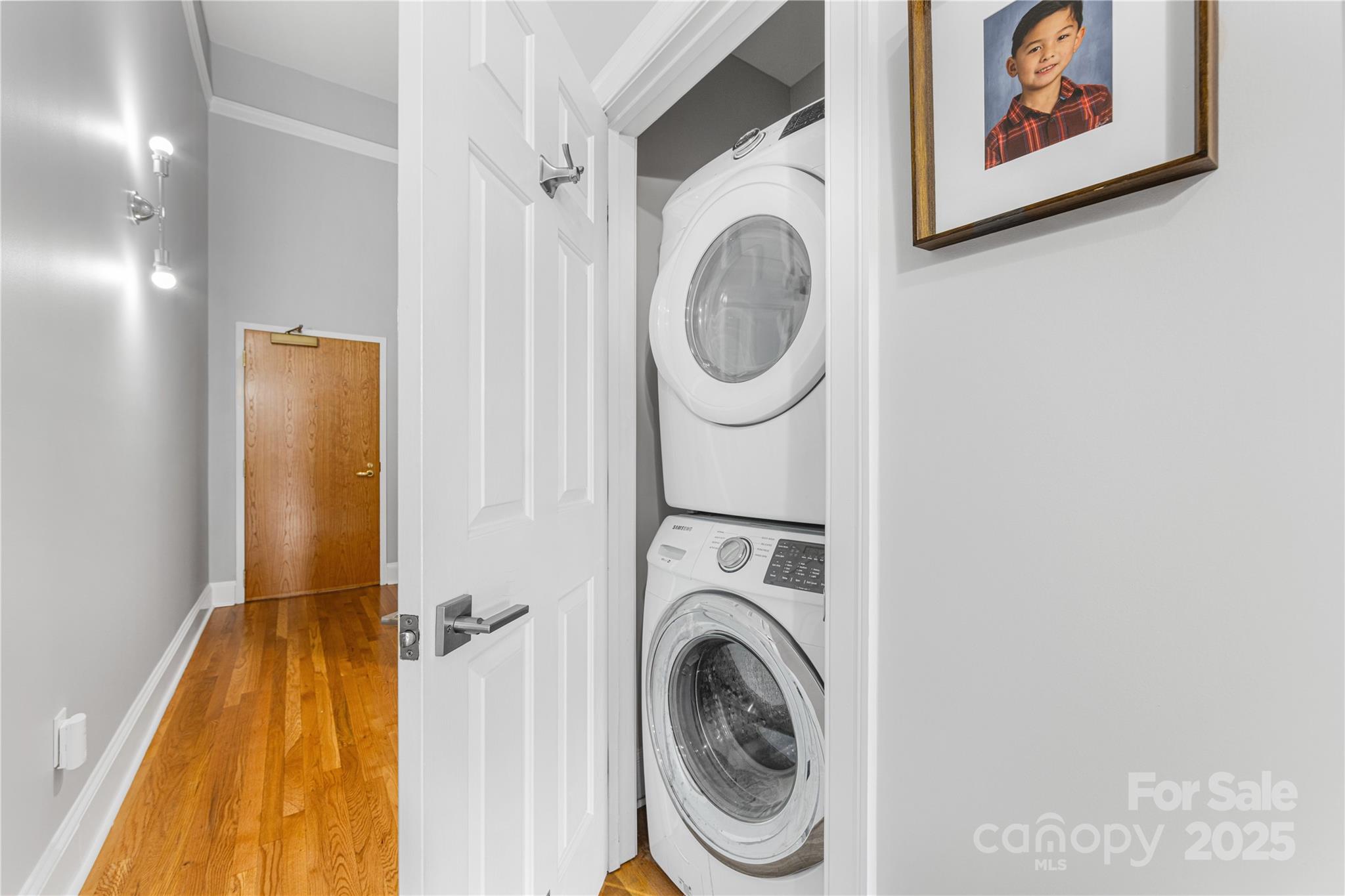 127 North Tryon Street, Unit 511 Charlotte, NC 28246 - Photo 27 of 32 a view of a hallway with washer and dryer