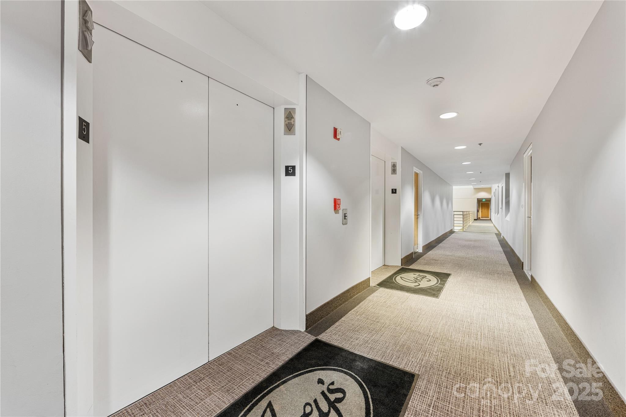 127 North Tryon Street, Unit 511 Charlotte, NC 28246 - Photo 3 of 32 a view of a hallway with storage