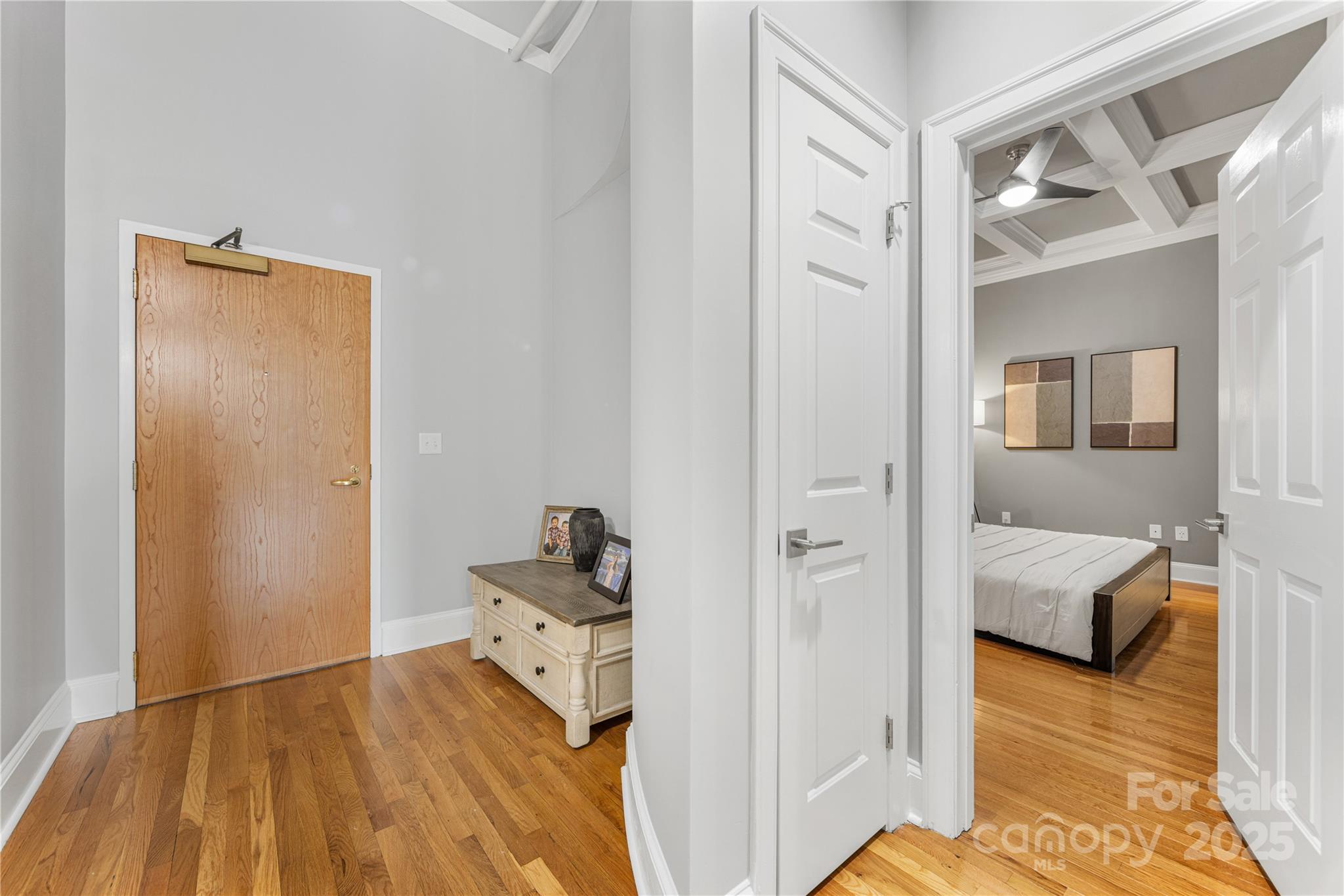 127 North Tryon Street, Unit 511 Charlotte, NC 28246 - Photo 5 of 32 a bedroom with a bed and wooden floor