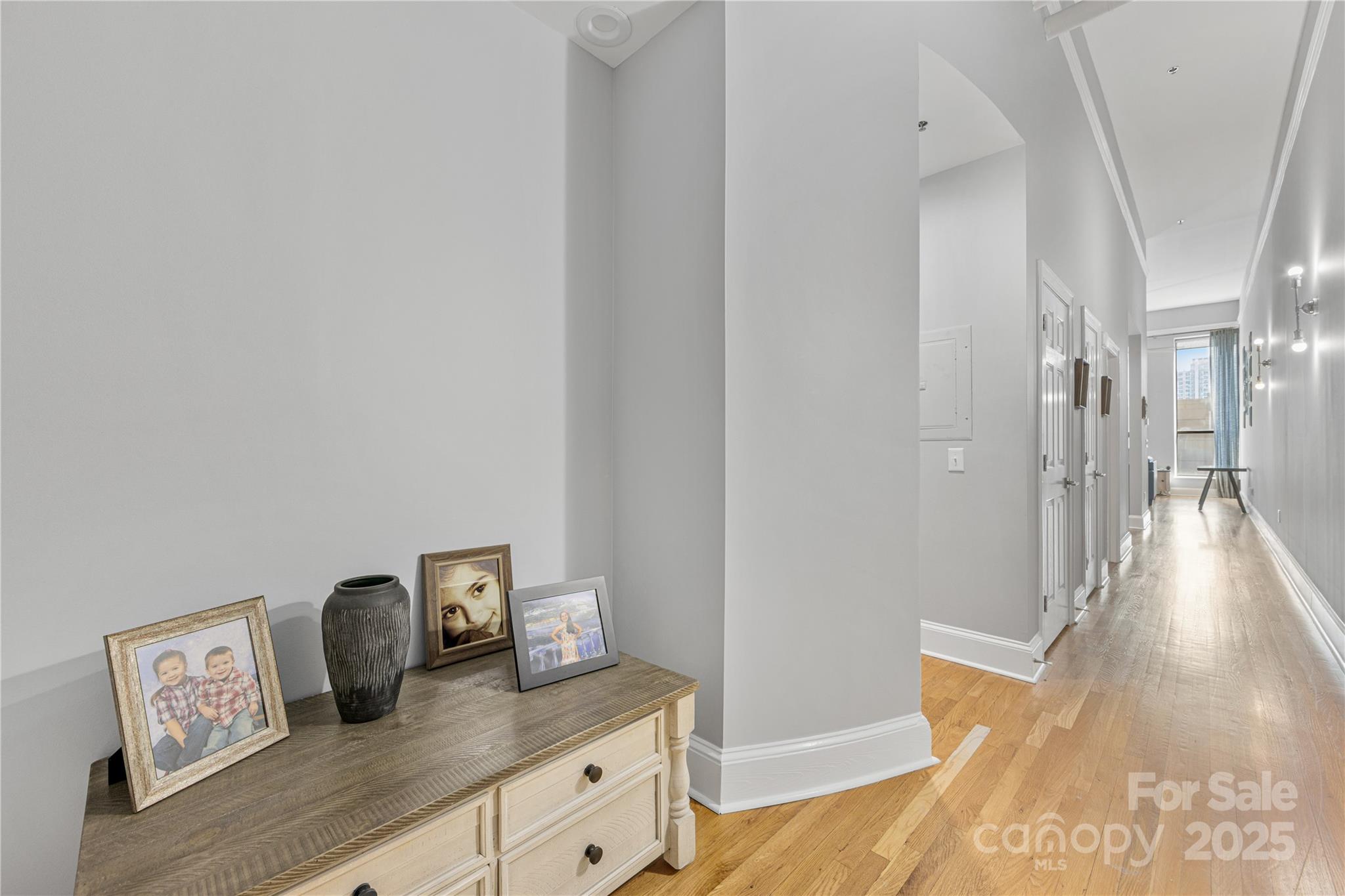 127 North Tryon Street, Unit 511 Charlotte, NC 28246 - Photo 6 of 32 a view of a hallway to a livingroom with wooden floor