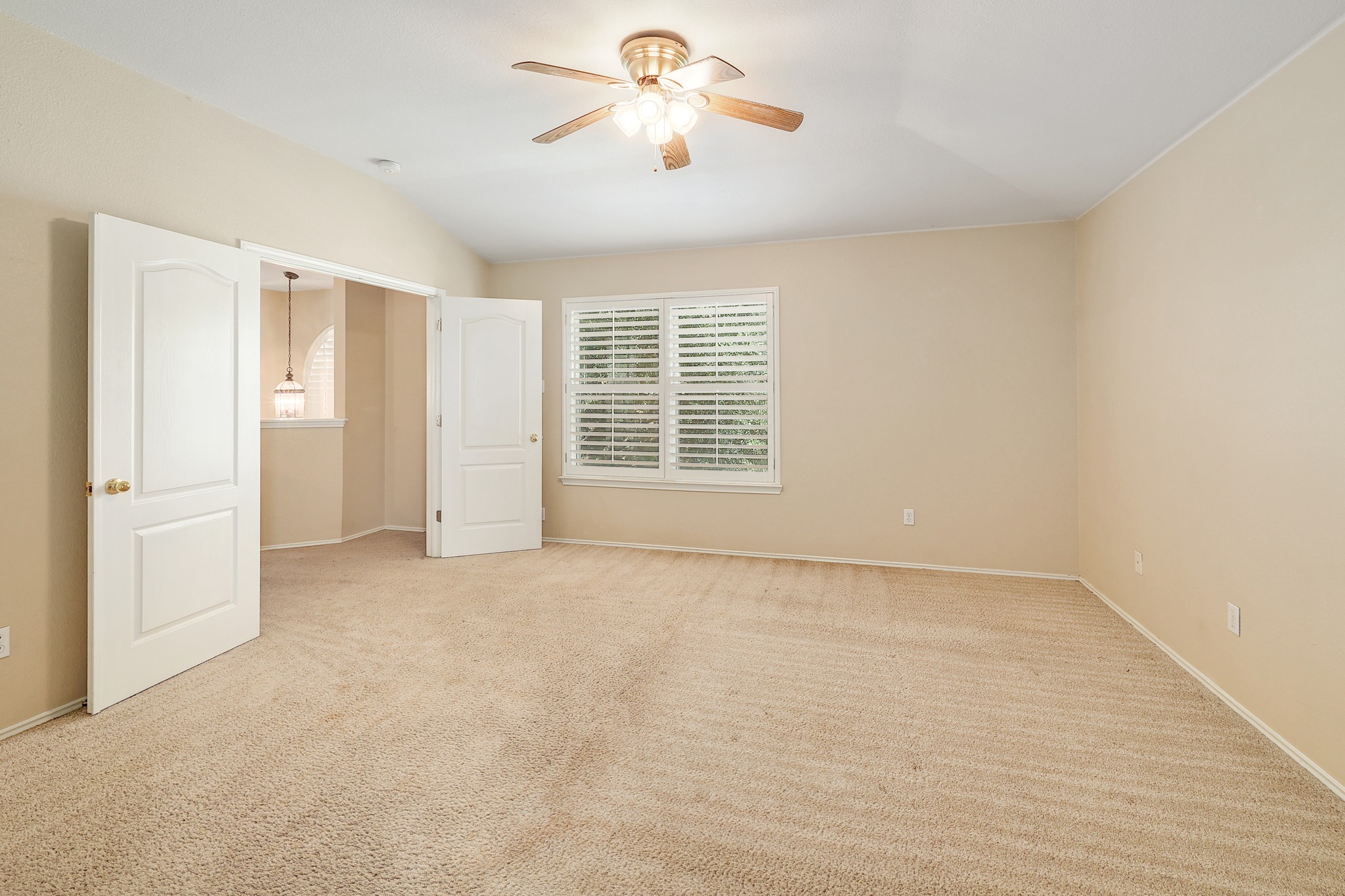 4615 Tello Path Austin, TX 78749 - Photo 18 of 31 Double doors open to a spacious room featuring wall-to-wall carpeting and shuttered windows.