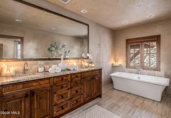 a spacious bathroom with a double vanity sink tub double and mirror