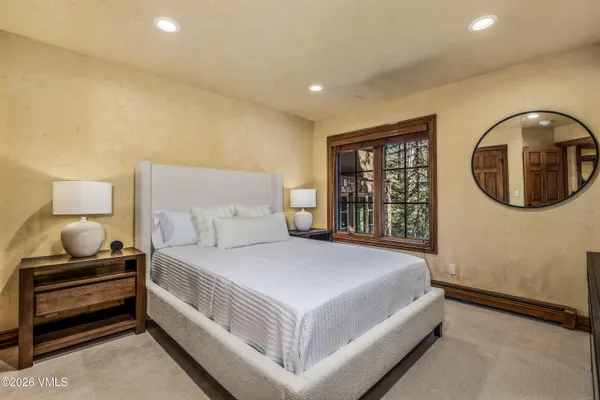 a bedroom with a bed and a large window
