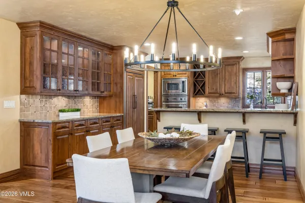 a kitchen with a table chairs stove and cabinets