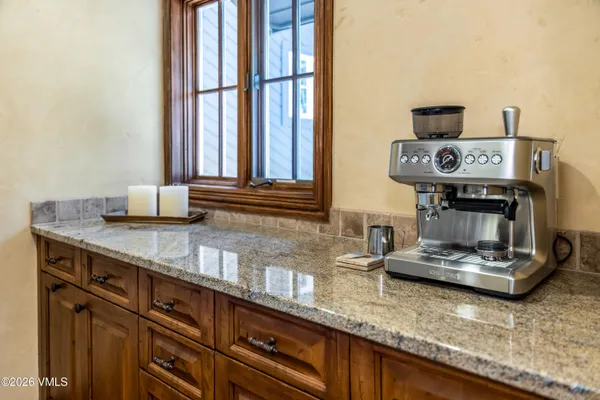 a kitchen with kitchen island granite countertop cabinets and window