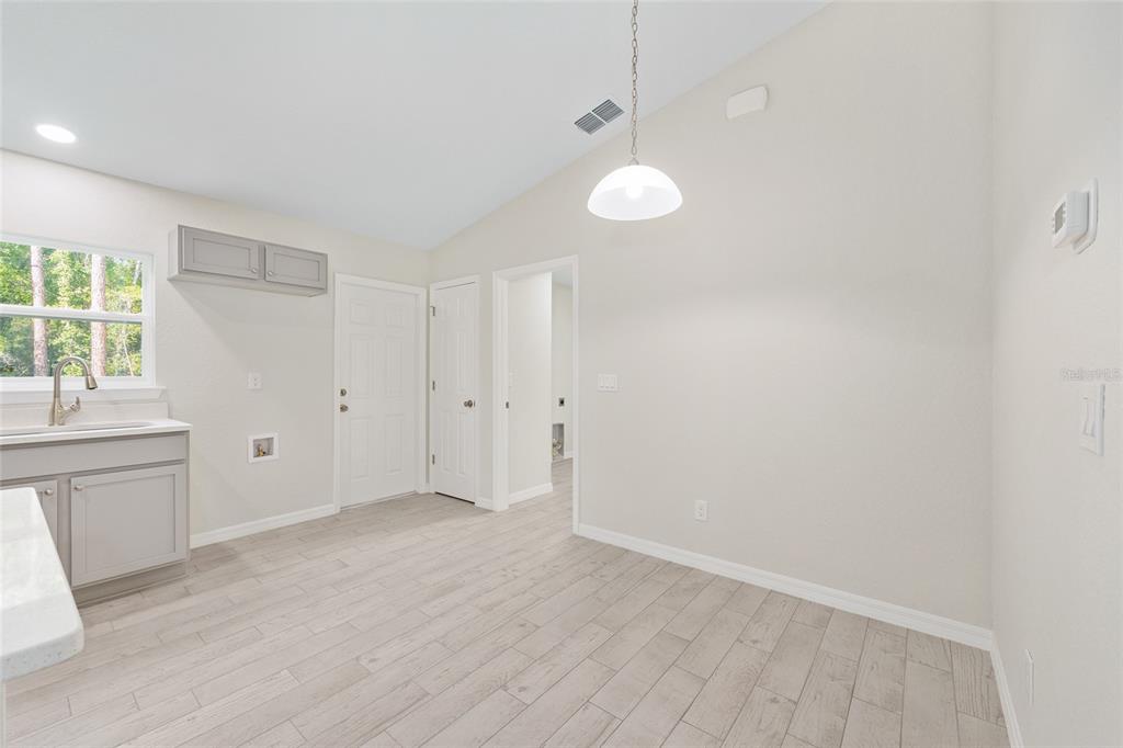 358 Locust Road Ocala, FL 34472 - Photo 15 of 48 wooden floor in an empty room with a window