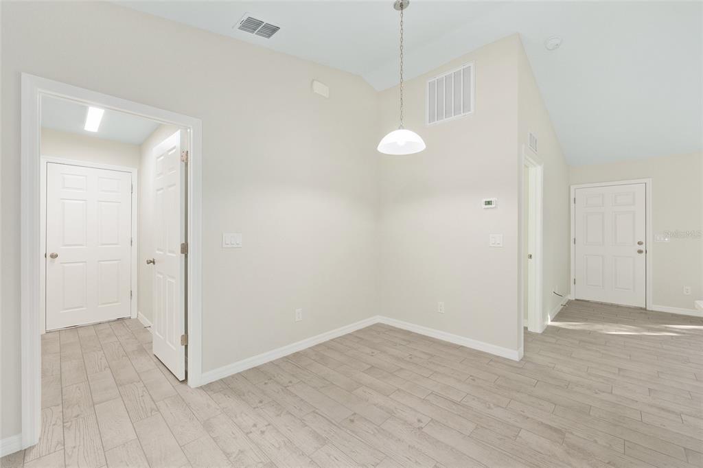 358 Locust Road Ocala, FL 34472 - Photo 16 of 48 a view of a room with wooden floor and white walls