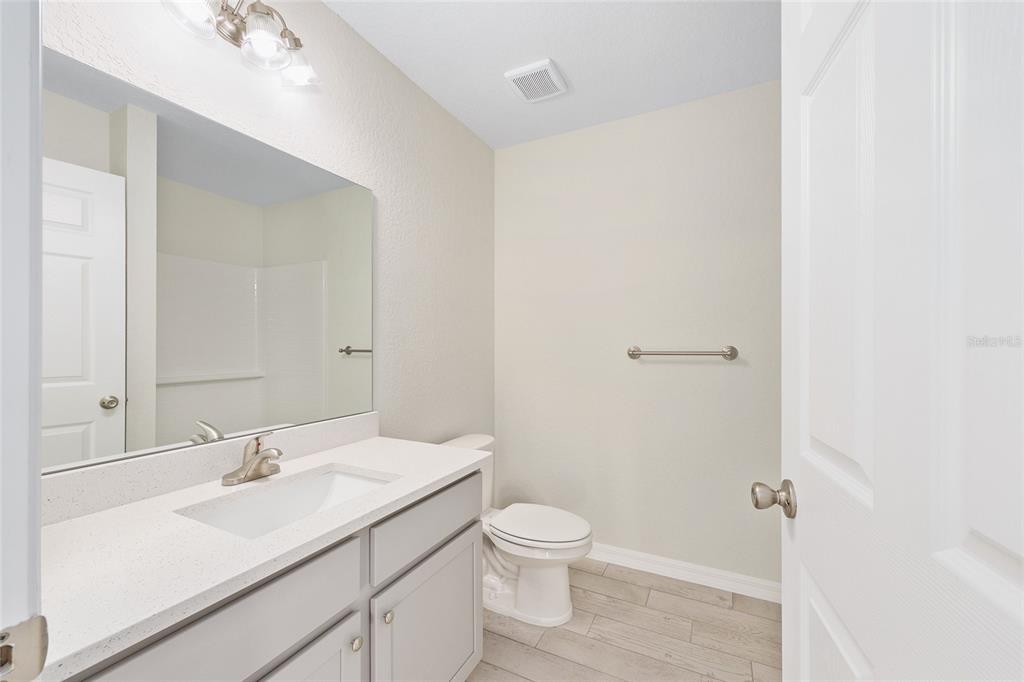 358 Locust Road Ocala, FL 34472 - Photo 24 of 48 a bathroom with a sink toilet and vanity