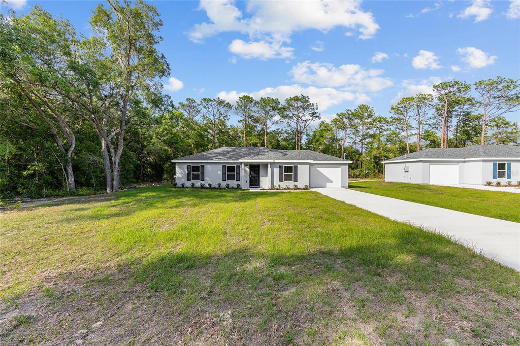 358 Locust Road Ocala, FL 34472 - Photo 3 of 48 a front view of a house with a garden