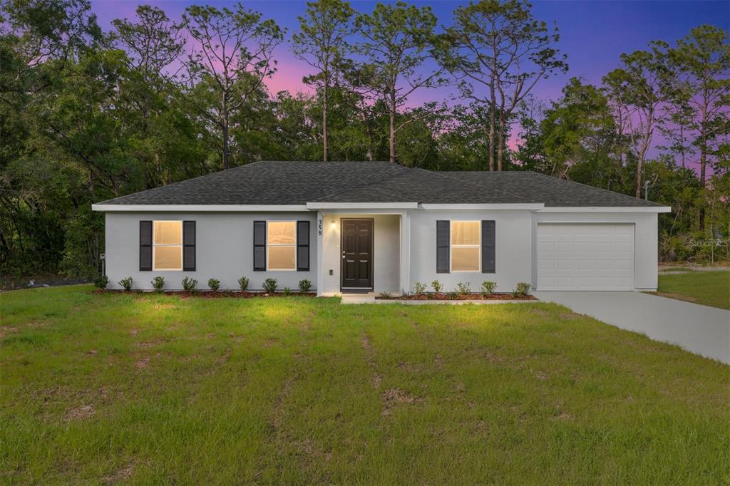 358 Locust Road Ocala, FL 34472 - Photo 4 of 48 a front view of a house with a garden