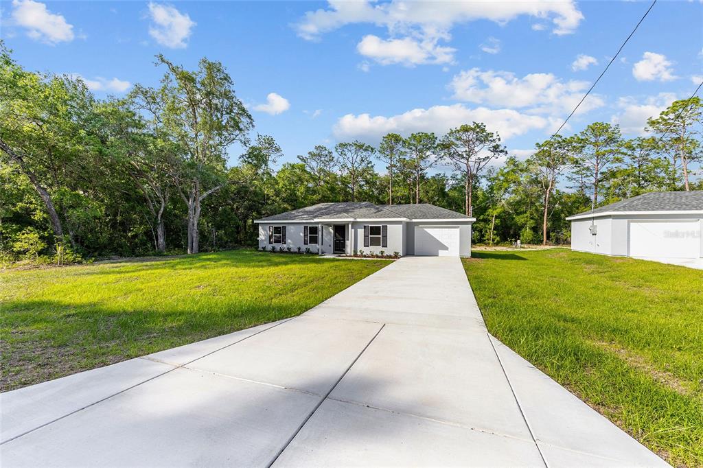358 Locust Road Ocala, FL 34472 - Photo 5 of 48 a front view of a house with garden