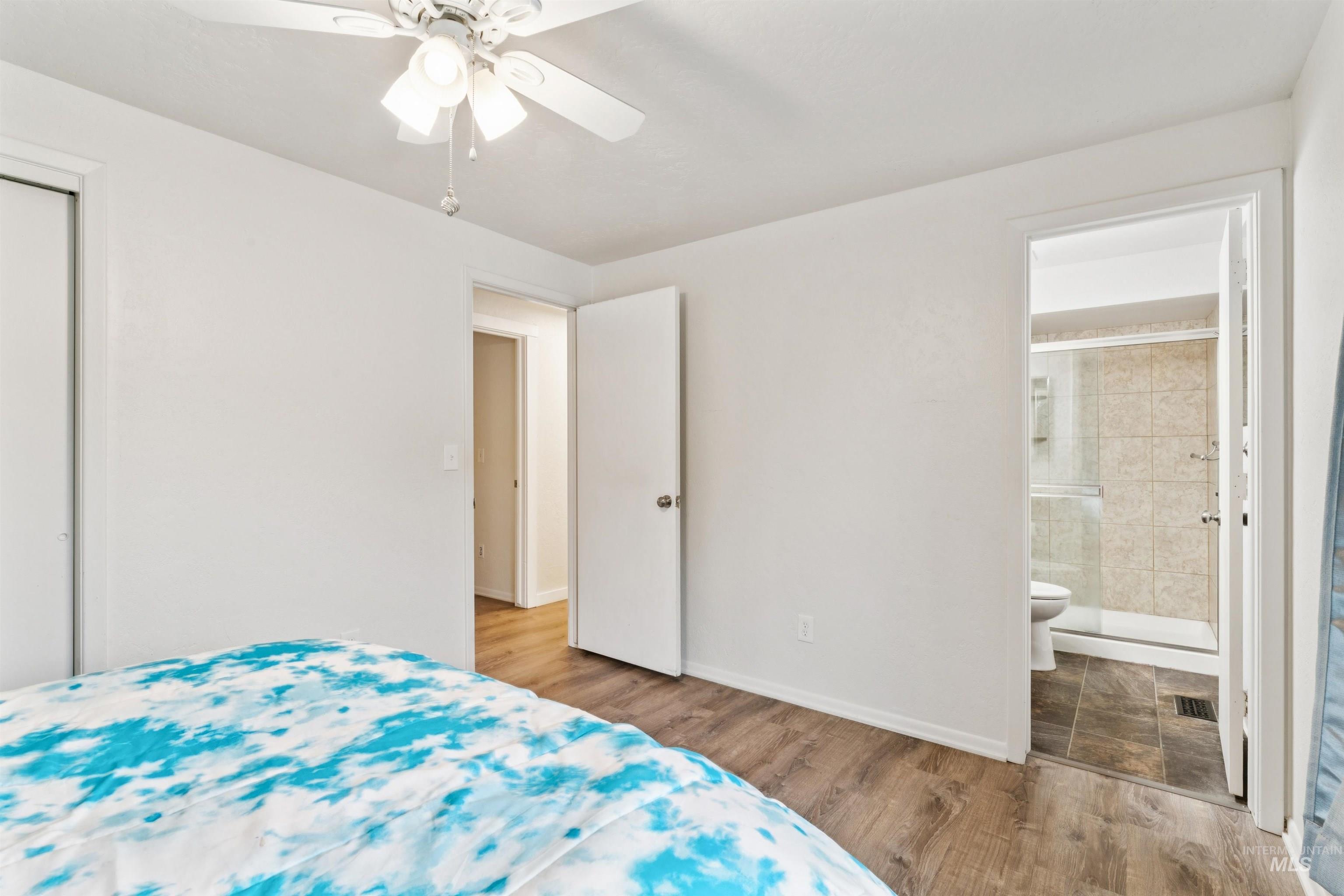 4811 North Leather Way Boise, ID 83713 - Photo 15 of 32 Bedroom with wood finished floors, ceiling fan, a closet, and connected bathroom