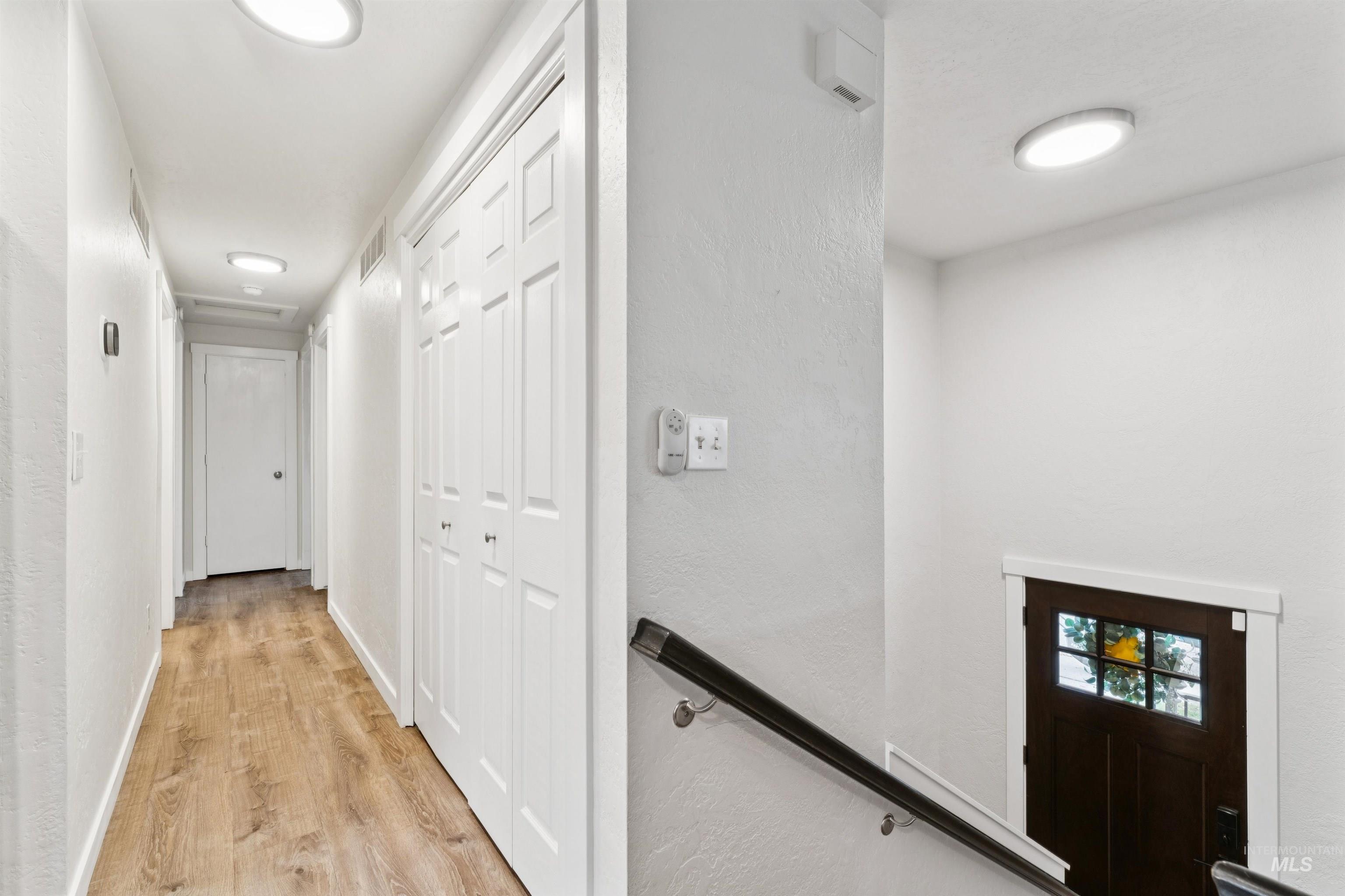 4811 North Leather Way Boise, ID 83713 - Photo 19 of 32 Corridor featuring light wood finished floors, a textured wall, and an upstairs landing