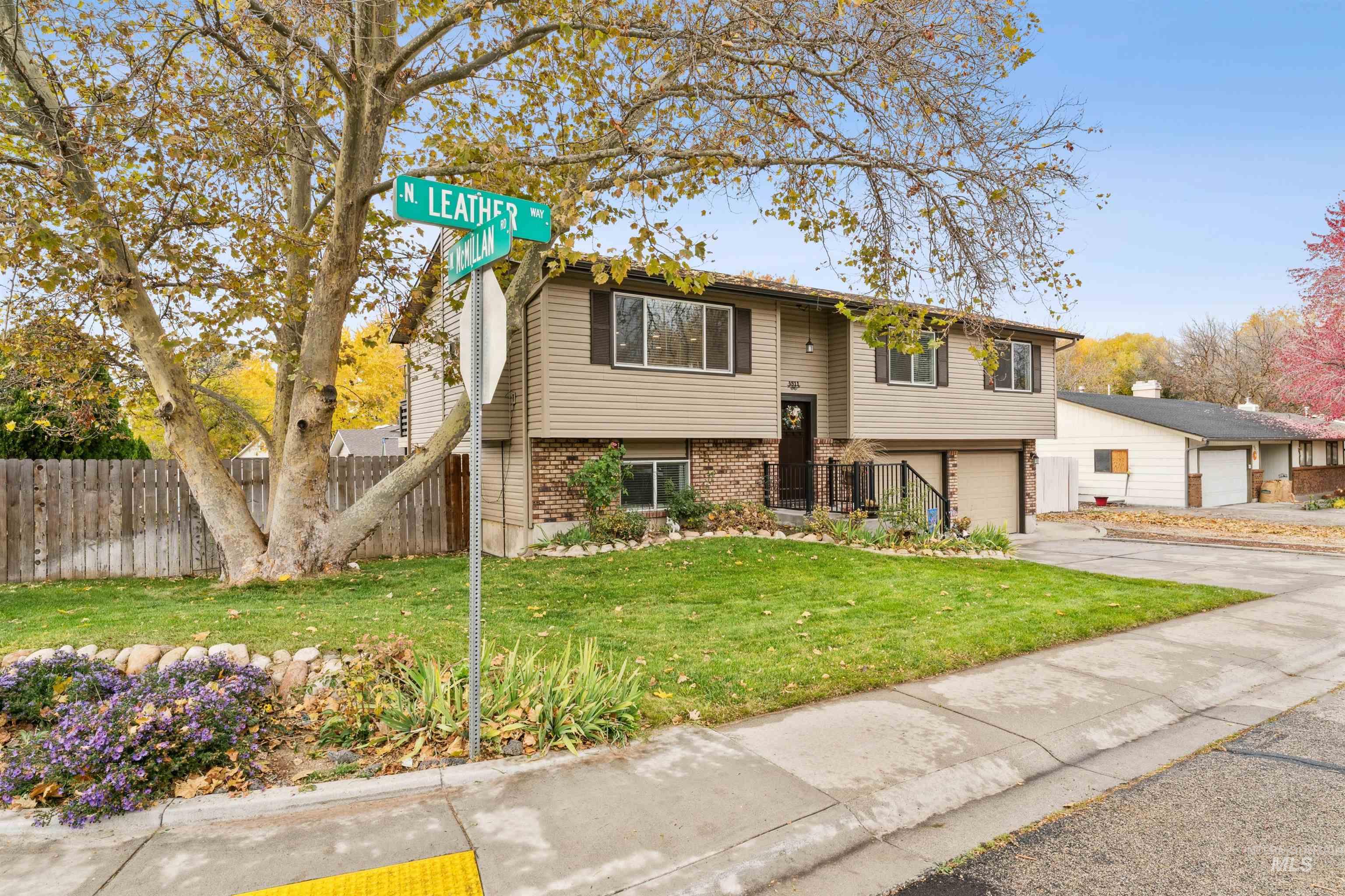 4811 North Leather Way Boise, ID 83713 - Photo 4 of 32 Split foyer home featuring brick siding, concrete driveway, and a garage