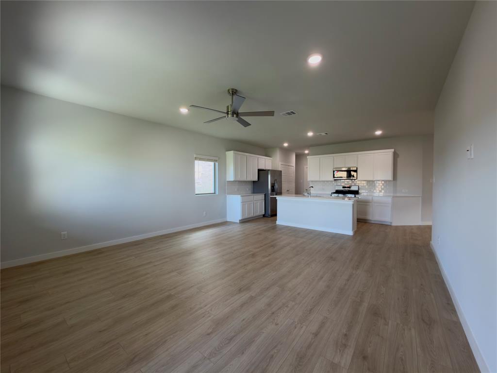 120 Millwood Road Lavon, TX 75166 - Photo 5 of 34 Open-concept living space featuring wood-finish flooring, recessed lighting, and a ceiling fan