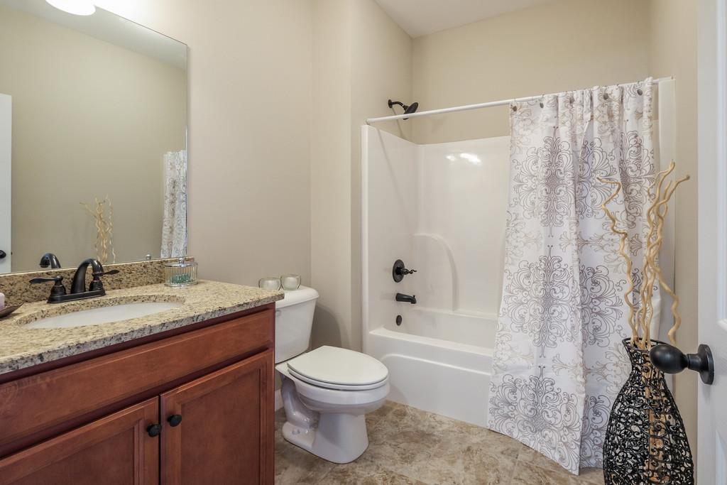 419 Kaiser Road Dickson, TN 37055 - Photo 20 of 27 a bathroom with a granite countertop sink toilet and shower