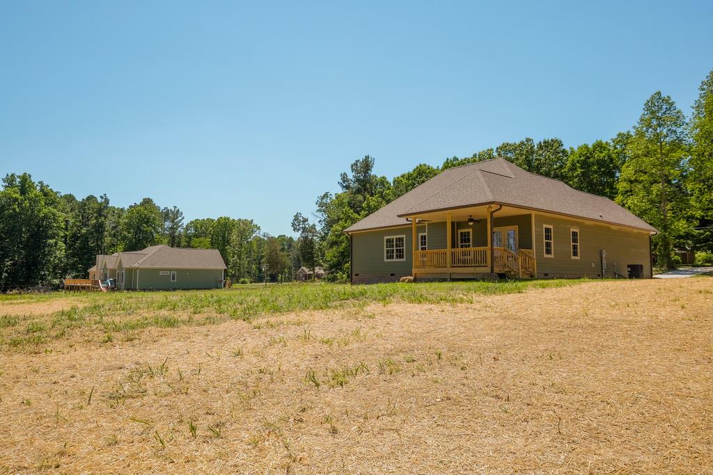 419 Kaiser Road Dickson, TN 37055 - Photo 24 of 27 a yellow house with a big yard and large trees