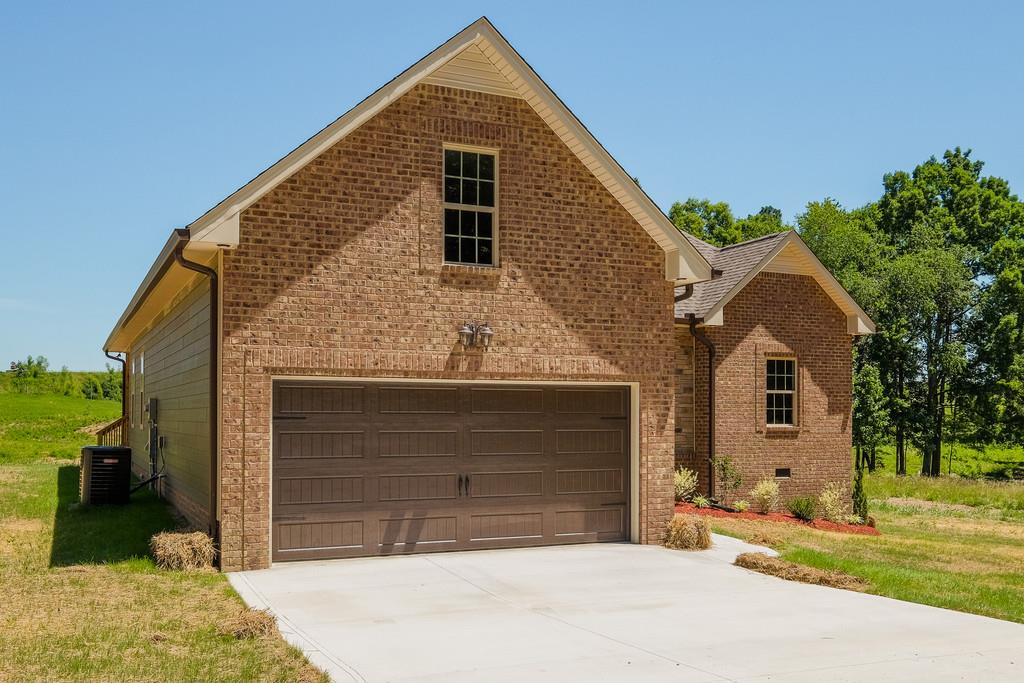 419 Kaiser Road Dickson, TN 37055 - Photo 26 of 27 a front view of a house with a yard and garage