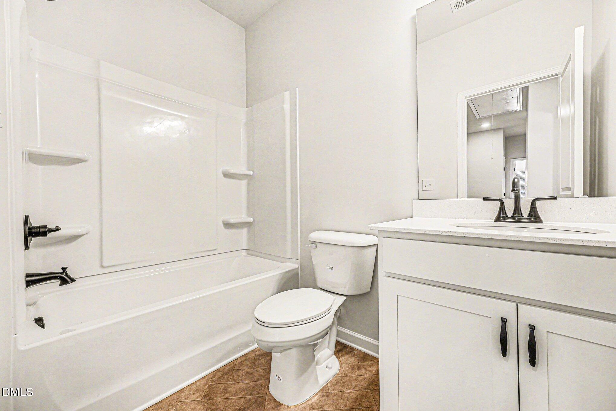 726 Orch Vista Circle Raleigh, NC 27606 - Photo 13 of 28 a bathroom with a sink a toilet and a bathtub