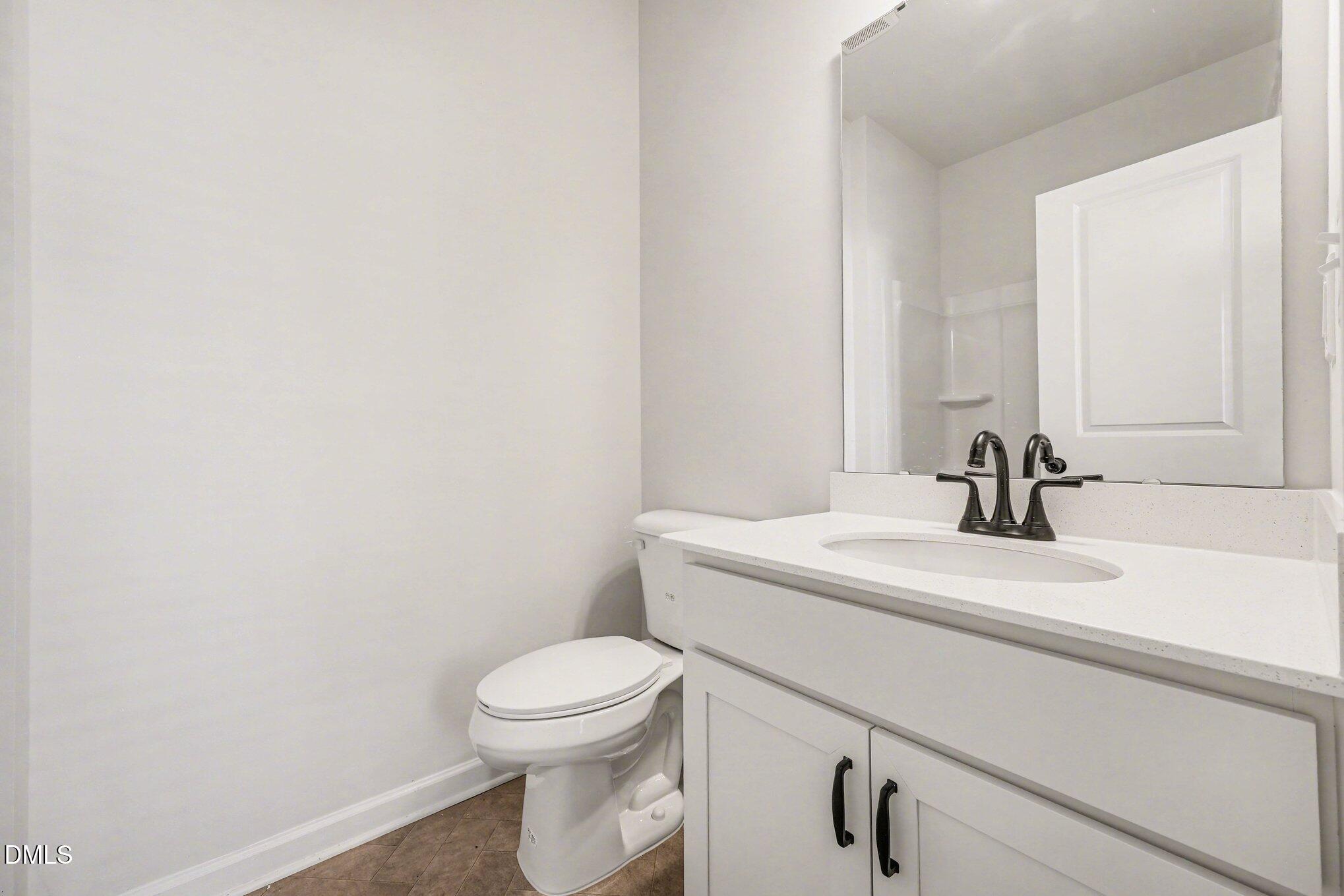 726 Orch Vista Circle Raleigh, NC 27606 - Photo 16 of 28 a bathroom with a sink a toilet and a mirror