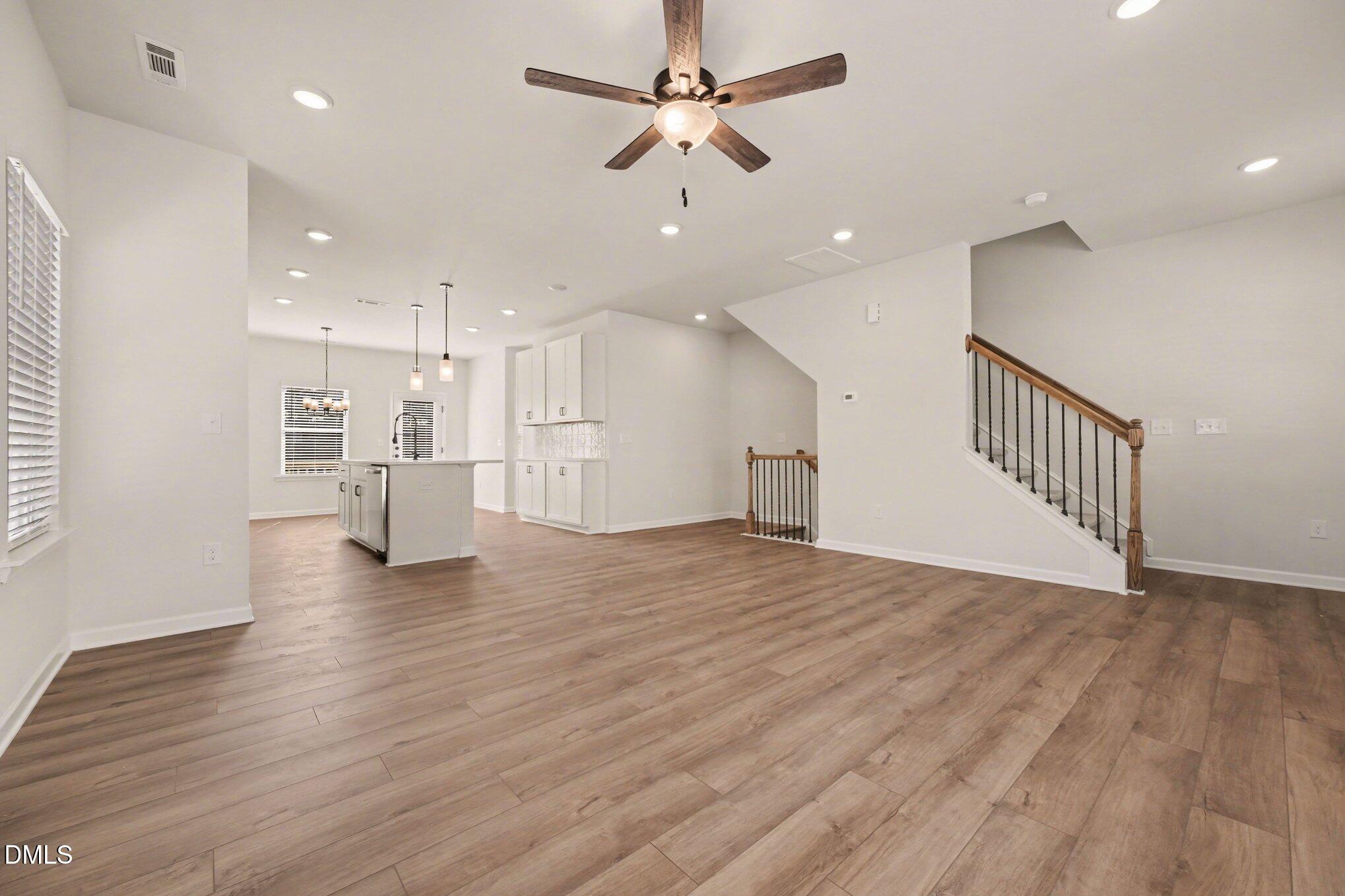 726 Orch Vista Circle Raleigh, NC 27606 - Photo 5 of 28 a view of empty room with wooden floor and ceiling fan
