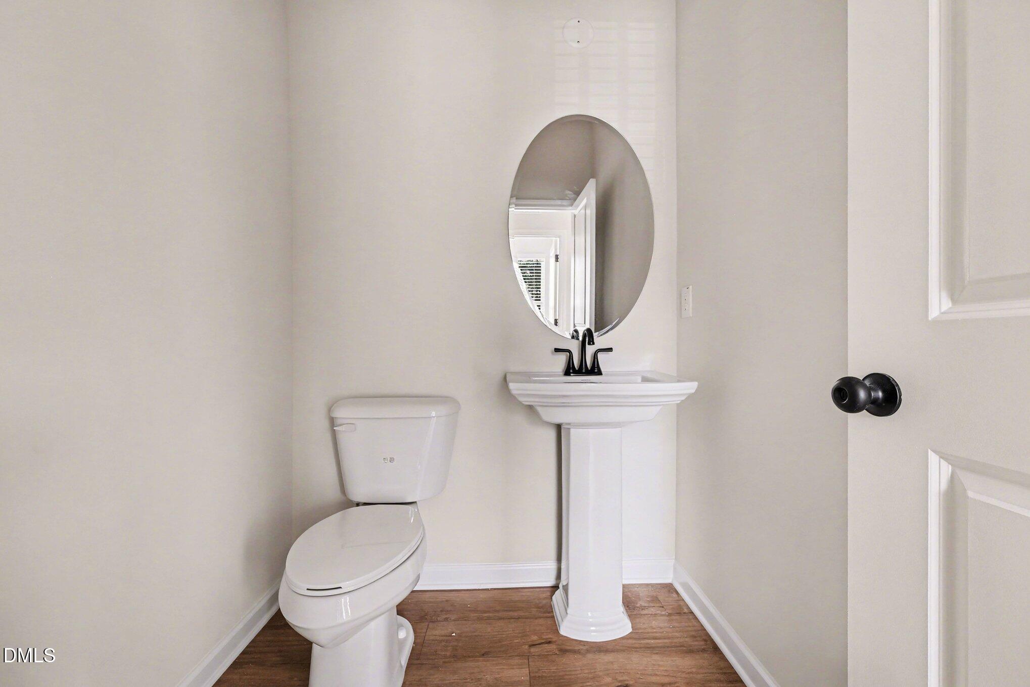 726 Orch Vista Circle Raleigh, NC 27606 - Photo 6 of 28 a bathroom with a toilet sink and mirror
