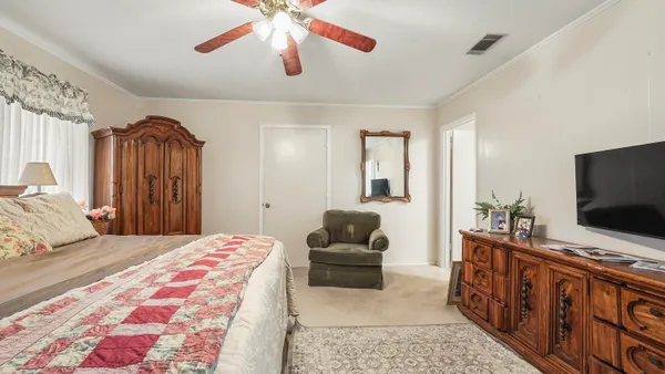 a bedroom with a bed and a chandelier