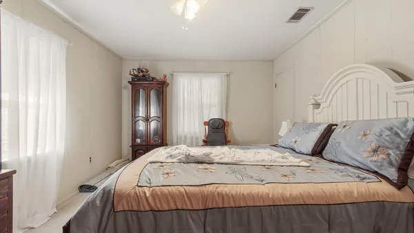 a bedroom with two beds and a flat screen tv