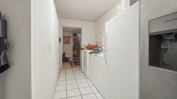 a view of a hallway with workspace and a window