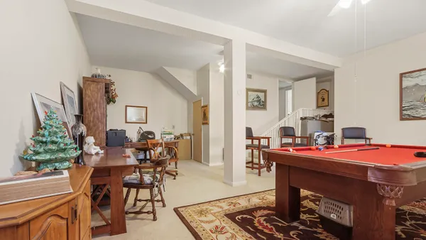 a view of a livingroom with furniture and a ceiling fan