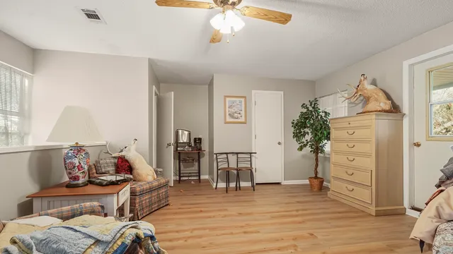 a living room with patio furniture and a potted plants