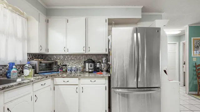 a kitchen with stainless steel appliances kitchen island granite countertop a sink and cabinets