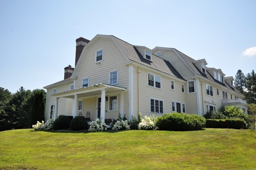 1228 Lowell Road Concord, MA 01742 - Photo 3 of 27 a view of a white house with a big yard and potted plants