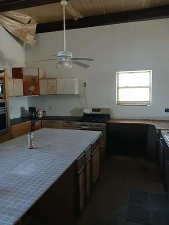 a kitchen with a sink a counter space and cabinets