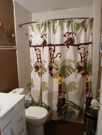 a bathroom with a toilet sink and mirror