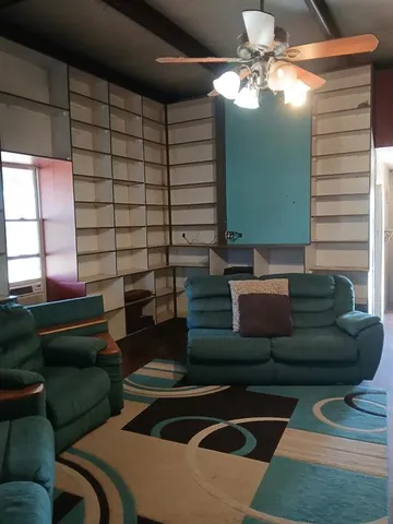 a living room with lots of furniture and a window