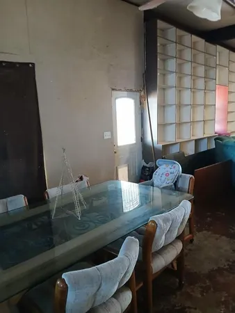 a dining room with furniture and a window