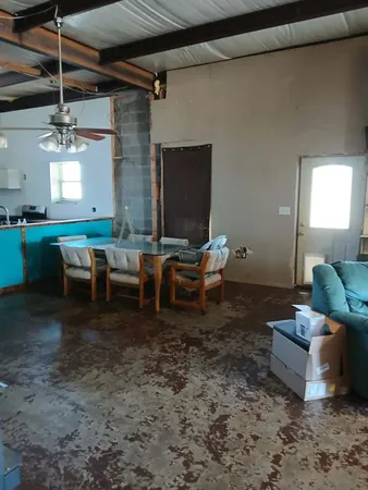 a living room with lots of furniture and a window