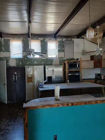 a kitchen with stainless steel appliances granite countertop a sink a stove and a microwave