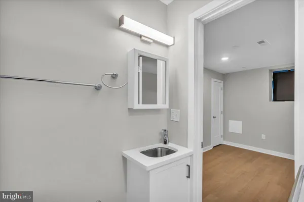 a bathroom with a sink and mirror